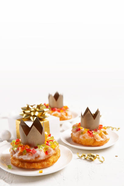istock Roscon de reyes, spanish three kings Christmas sweet cake with winter decorations on white background 1441945399