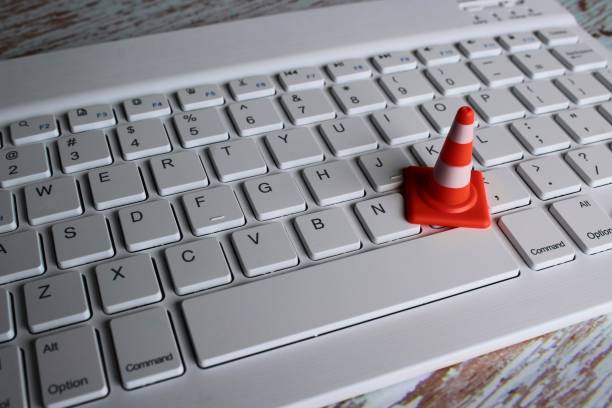 Safety cone and keyboard computer stock photo