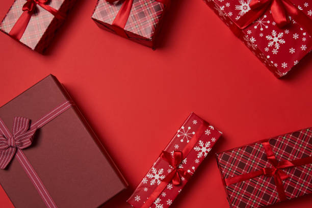 istock Red gift boxes with red ribbon on red background. 1441950162