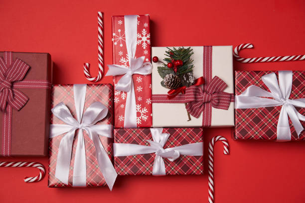 istock Group of gift boxes with candy canes on red background. 1441950393