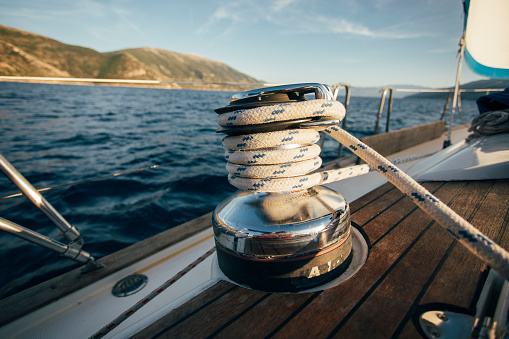 Sailing winch with rope on sailboat.