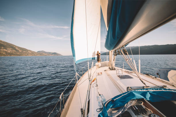 istock Man taking photos from sailboat bow 1441952439