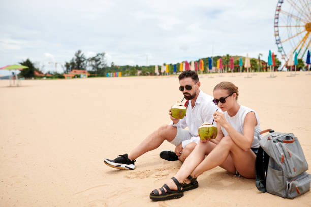 istock Couple Rresting on Sandy Beach 1441955032