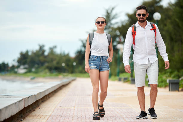 istock Couple Walking along Coastline 1441955033