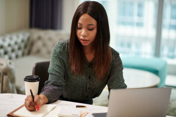istock Female Entrepreneur Filling Planner 1441955203