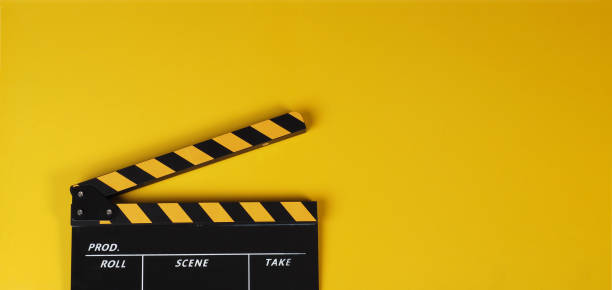 istock Clapper board or yellow movie slate on yellow background. 1441956265