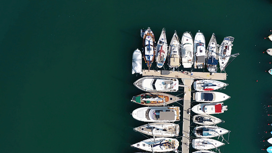Aerial view of large and small yachts and sailboats moored at the quay. Top view of Boats in Procida, Italy