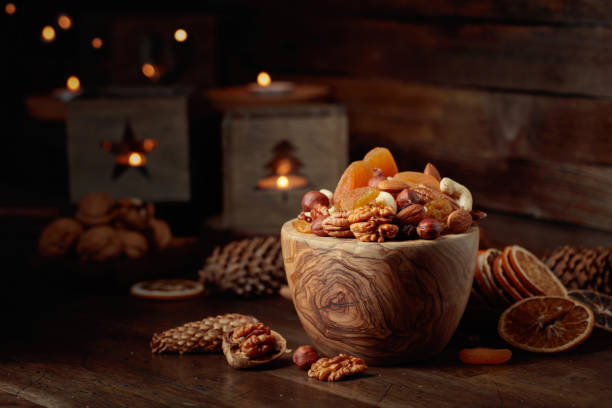 istock Dried fruits and assorted nuts on a wooden table. 1441967299
