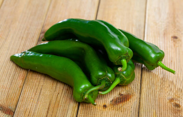istock Whole peppers on wooden table 1441969223