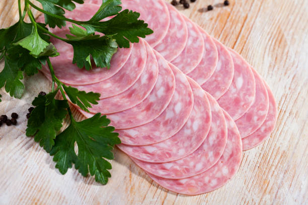 istock Catalan sausage slices on wooden background 1441969435