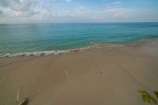 A serene image of a beach in Cayo Coco, capturing the pristine white sands and crystal-clear turquoise waters of this idyllic tropical paradise. The scene embodies the tranquil beauty of this Cuban island, known for its unspoiled beaches and serene natural landscapes.