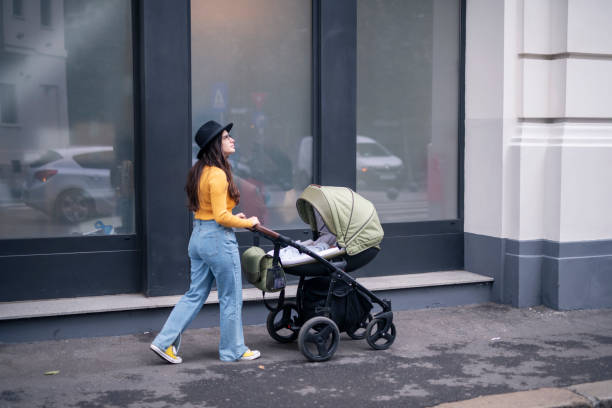 istock Woman on a street pushing a stroller. 1441978074