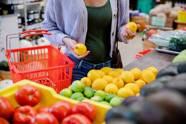 Unrecognizeable grocery shopper browses produce