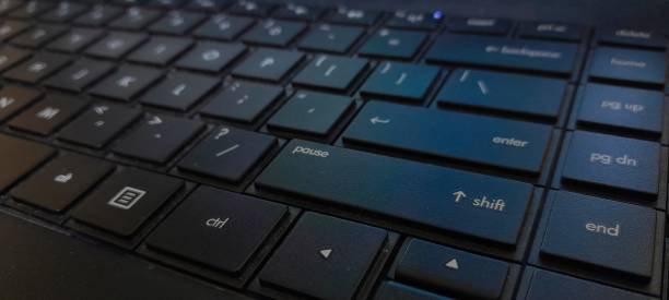 istock Close up of laptop keyboard with key and light 1441979288