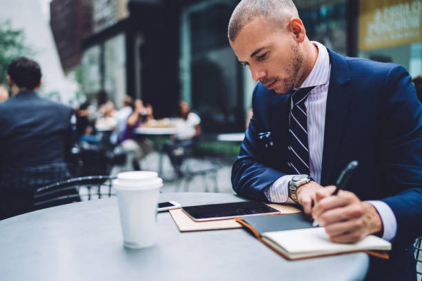 istock Focused entrepreneur working with tablet in street cafe 1441979507