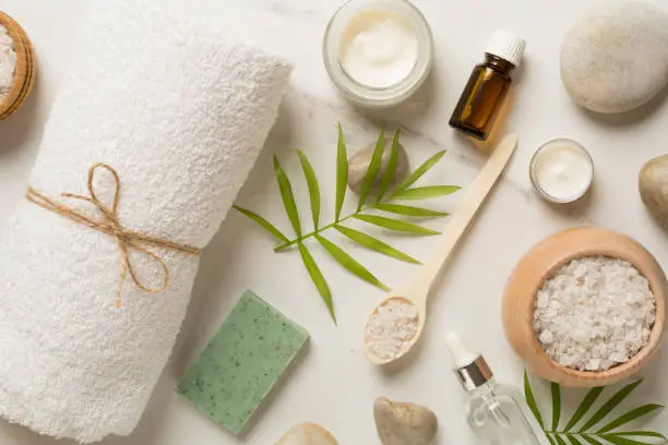 Photo of Composition with spa products on marble background, top view