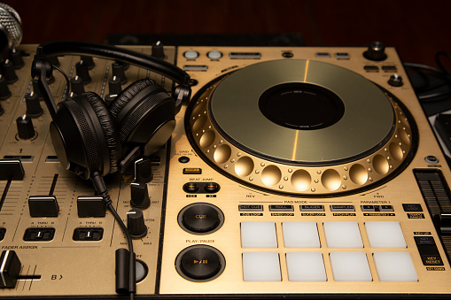 Black headphones on gold-plated dj table