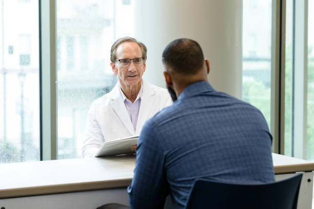 istock Specialist meets with unrecognizable male patient 1441980118