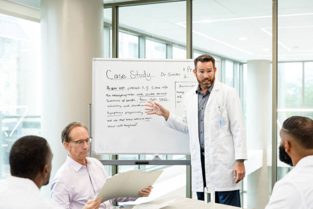 istock Diverse colleagues discuss patient case study in hospital conference room 1441980123