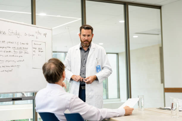 istock Two mature male doctors discuss patient case study 1441980124
