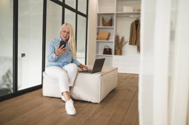 istock Blonde smiling woman having a call and looking peaceful 1441981264