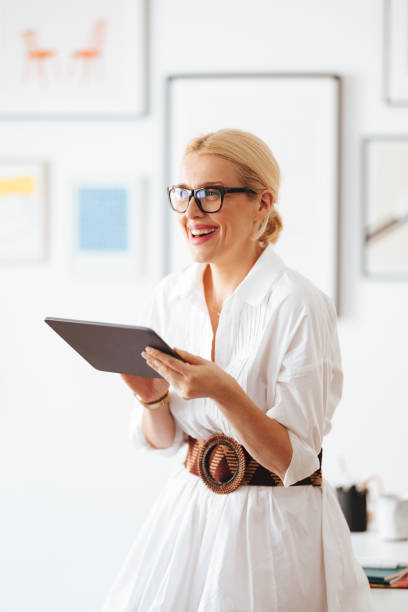 istock Happy Businesswoman Using A Digital Tablet At Work 1441983648