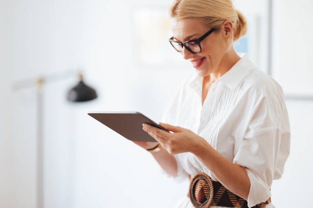 istock Smiling Businesswoman Using A Digital Tablet At Work 1441983652