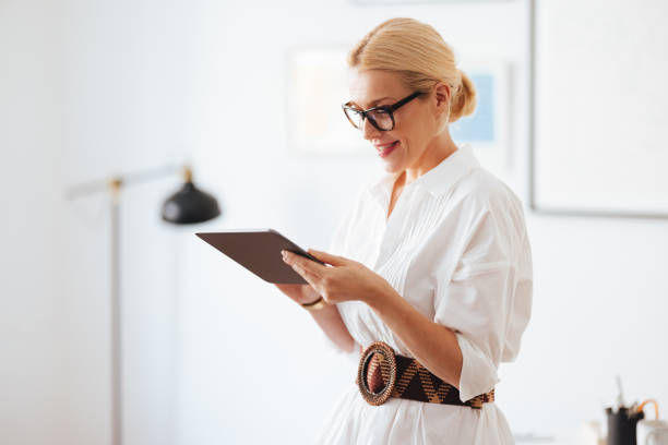 istock Happy Businesswoman Using A Digital Tablet At Work 1441983653