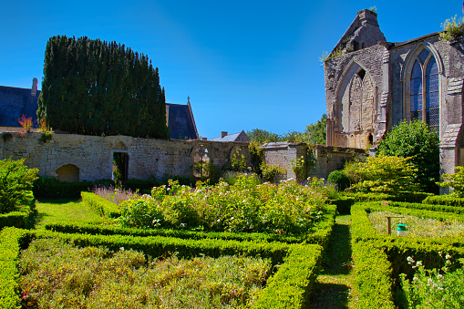 Longue abbey garden with ruined church