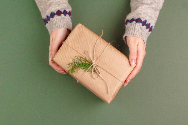 istock beautiful gift box wrapped in holiday paper with bow, top view 1441986663