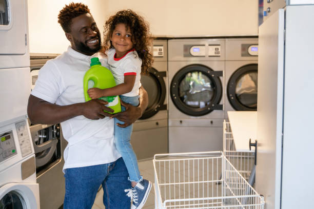 istock Loving father and his child at a public launderette 1441987014