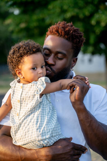 istock Affectionate dad kissing his child on the cheek 1441987064