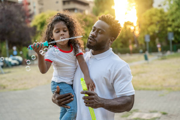 istock Child and her parent involved in the bubble game 1441987108