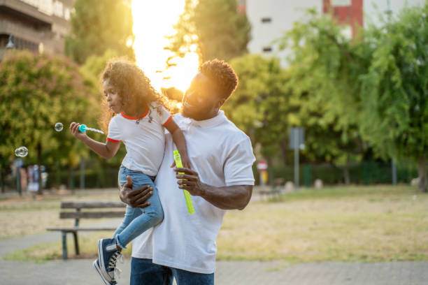 istock Child and her parent in the park 1441987115