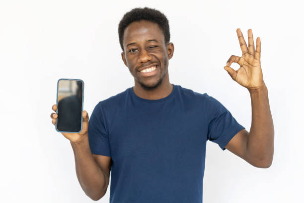 istock Happy man holding phone, showing okay sign 1441987483