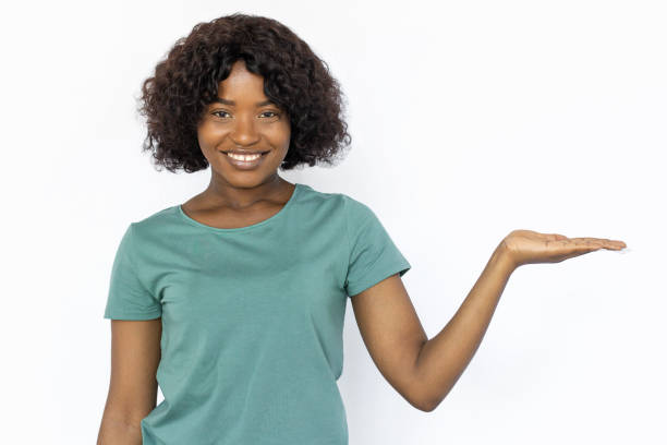 istock Smiling young woman holding something on palm 1441987526