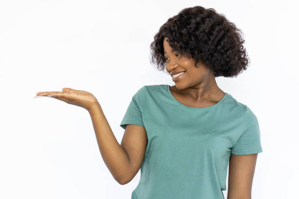 istock Smiling young woman holding something on palm 1441987529