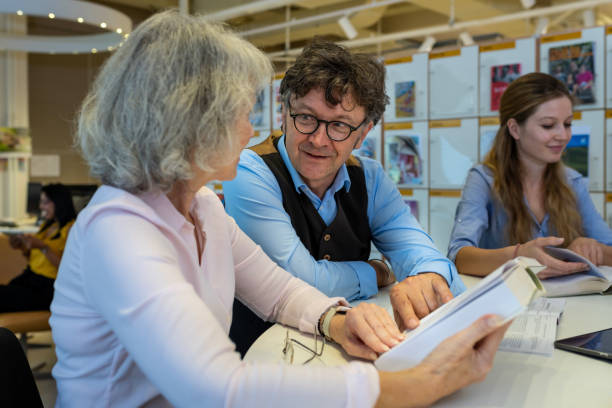 istock Small group of people reading and talking in the library 1441988524