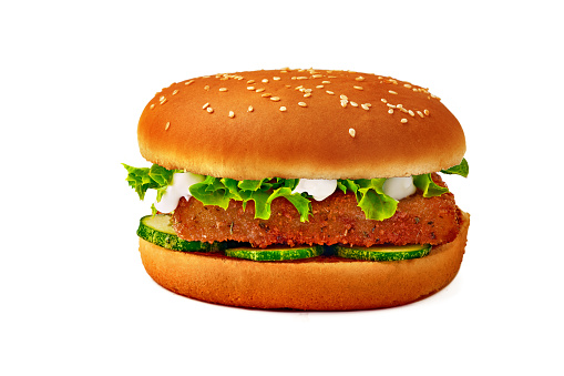 A burger bun with sesame seeds on white background.