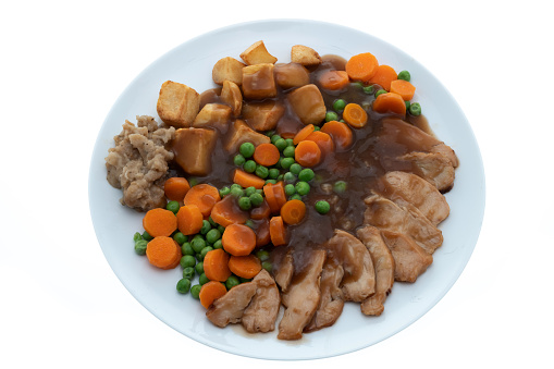 Roast chicken dinner with vegetables and gravy - white background
