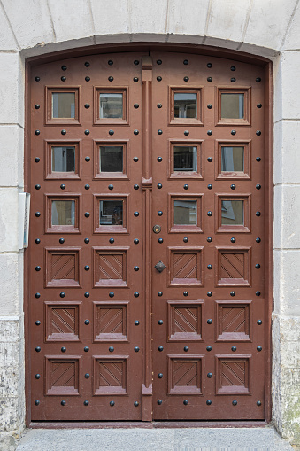 Estonia, Tallinn - July 21, 2022: Brown stylish door with 12 small windows at Pikk 62, where rooms can be rented.