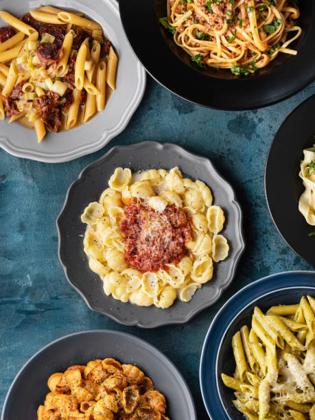 istock Various kinds of cooked  pasta and noodles over background, Pasta, Macaroni, Pasta variation, Collection of different pasta on cooking table 1441992830
