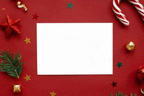istock Christmas card flat lay. Modern greeting card mock up composition with christmas decorations on red background. Empty postcard template with space for text. Merry Christmas and Happy Holidays! 1441994015