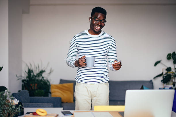 istock Happy Businessman Talking On A Video Call While Drinking Cup Of Coffee At Home 1441994351
