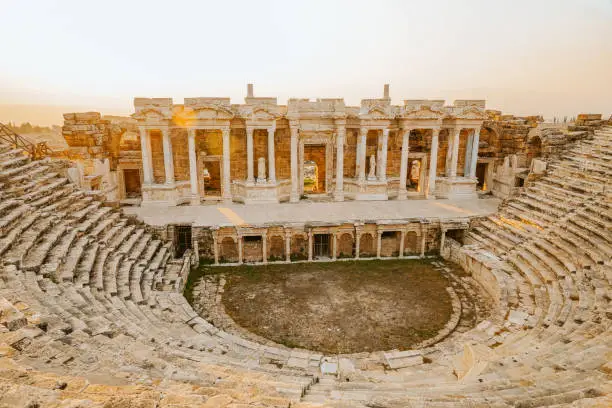 Denizli, Turkey. Ruins of a large amphitheater in the ancient city of Hierapolis near Pamukkale. Colonnade on the main street of ancient ruined city Hierapolis in Turkey.
