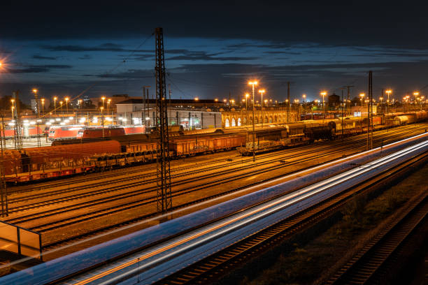 istock Cargo train depot in Mannheim at night with moving train 1441994435