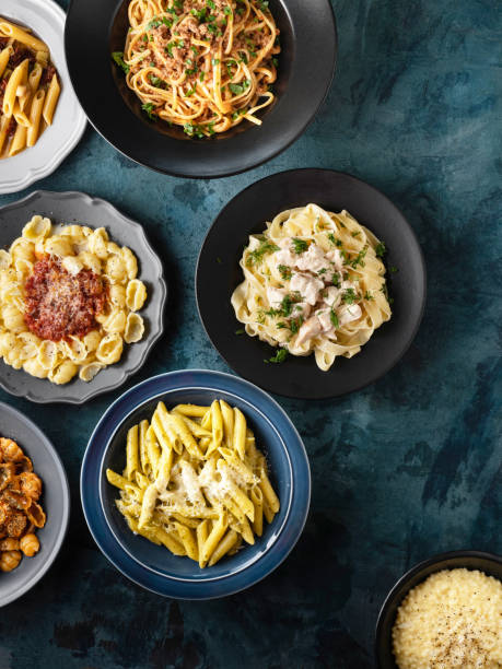 istock Various kinds of cooked  pasta and noodles over background, Pasta, Macaroni, Pasta variation, Collection of different pasta on cooking table 1441994461