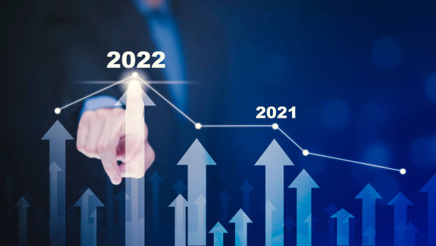 istock Business growth data chart arrow with diagram 2022 budget, Businessman pointing arrow graph corporate future growth year 2021 to 2022, Development to success and motivation. 1441994549