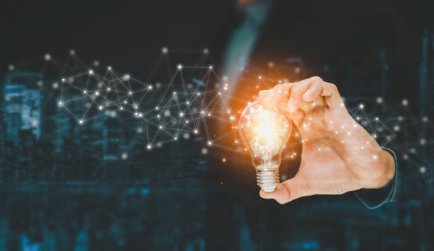 istock business hand holding illuminated light bulb, idea, innovation and inspiration concept.concept of creativity with bulbs that shine glitter, creativity with bulbs that shine glitter.Inspiration of idea 1441994570