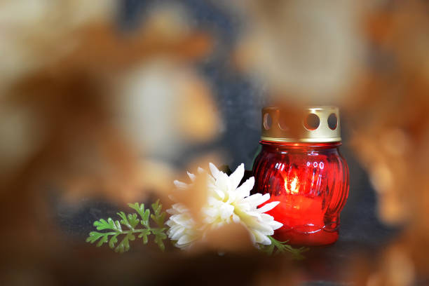 Burning candle and white chrysanthemum. Sympathy card background with copy space